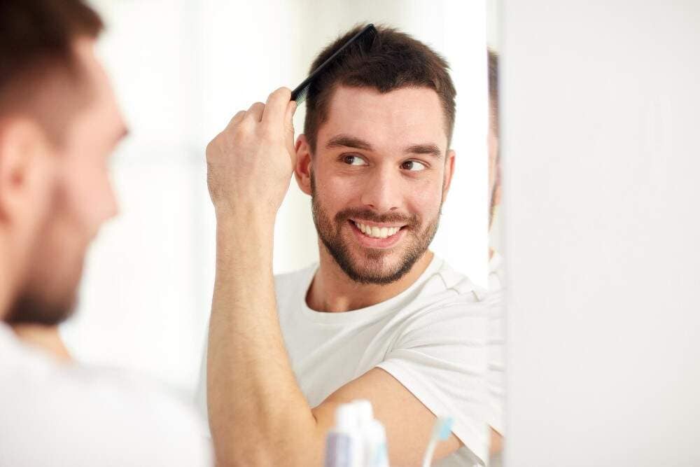 Image illustrating a man enjoying his new hair growth after a hair transplant.