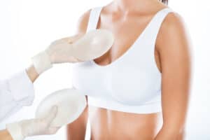 Medical professional preparing for breast augmentation surgery on a patient in Albania.