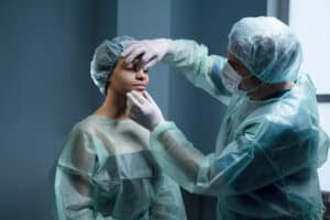 Surgeon performing rhinoplasty consultation in Albania clinic.