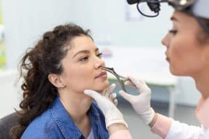 Woman undergoing revision rhinoplasty in Albania with a specialist.
