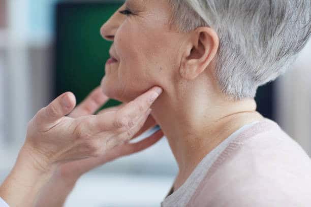 Woman undergoing neck lift surgery to improve jawline and neck contour.