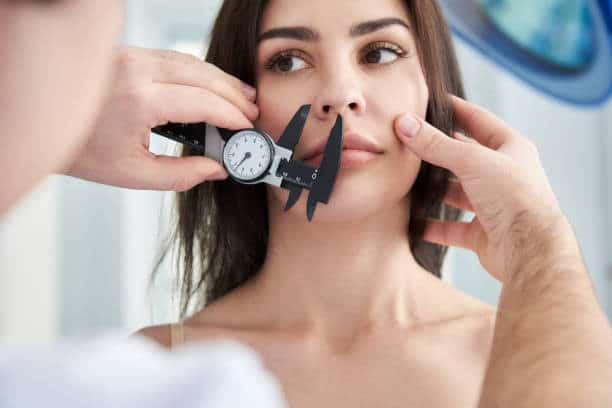 Woman undergoing rhinoplasty consultation in Albania for medical tourism.