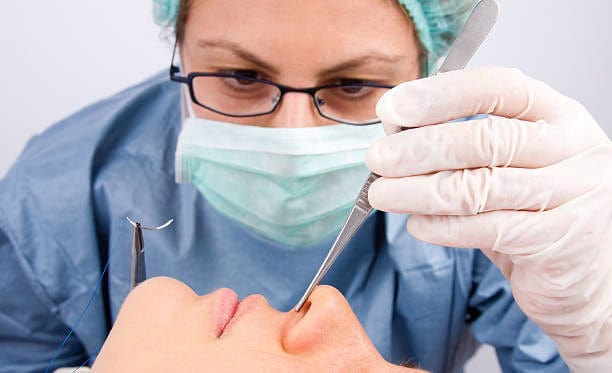 Surgeon performing rhinoplasty surgery in Albania for cosmetic nose enhancement.