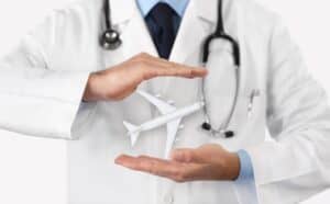Medical professional holding a model airplane, symbolizing medical tourism in Albania.